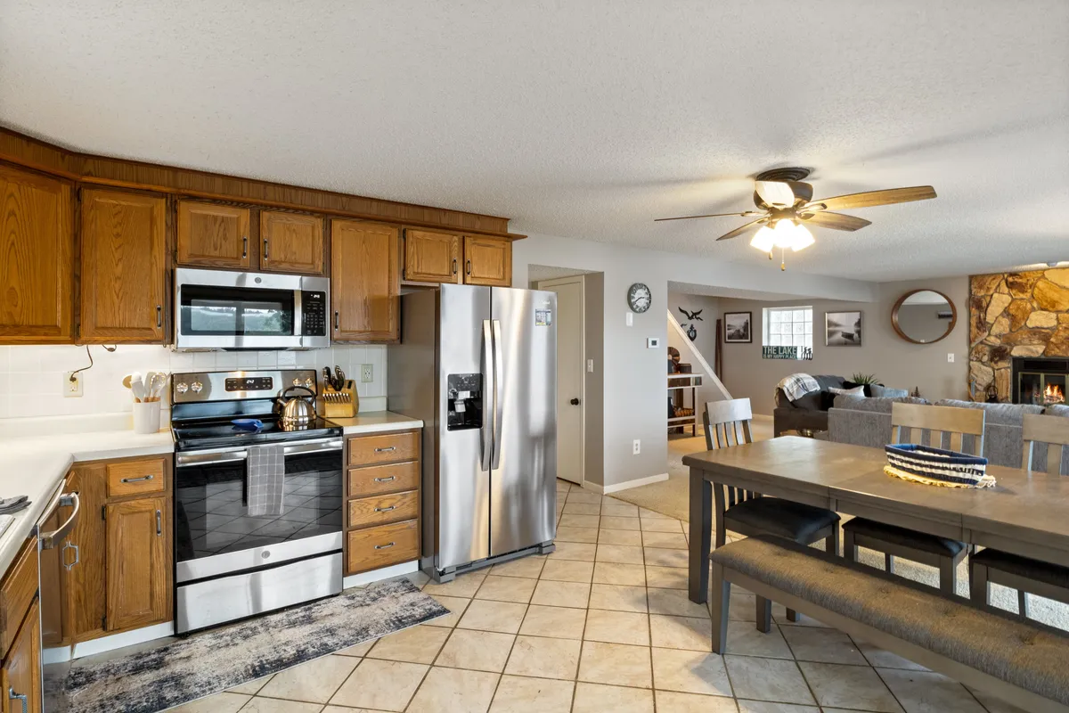 A well-appointed kitchen with modern appliances, a dining table adjacent, and a living room area beyond. The space is bright and welcoming, designed for cooking, dining, and socializing.